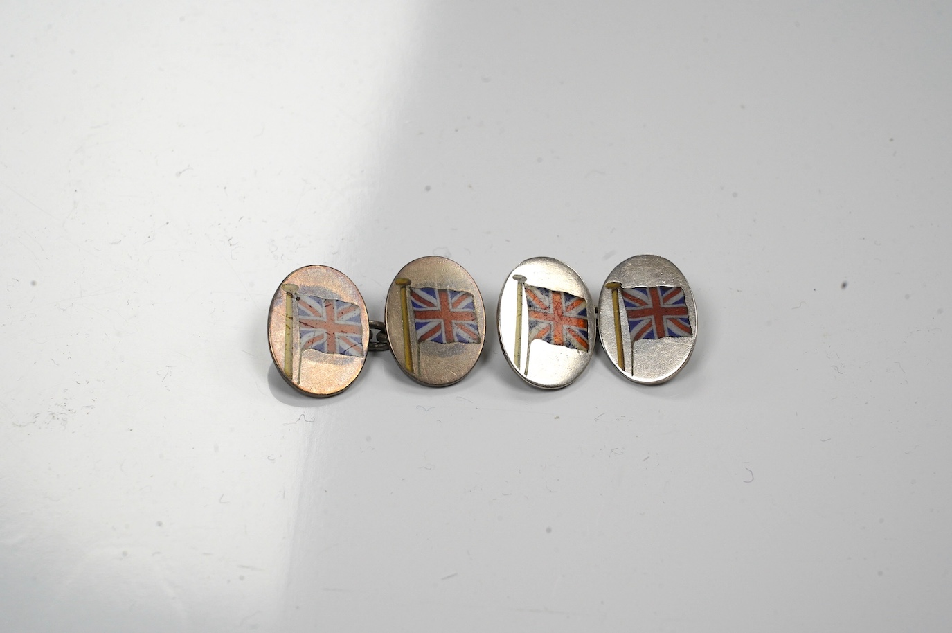 A pair of white metal and enamel oval 'Union Jack' cufflinks. Condition - poor to fair